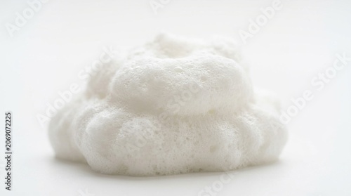 White soapy foam bubbles pile close-up isolated on white background