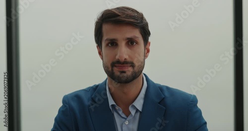 Portrait of bearded Hispanic businessman in formal jacket nods head in office. Latin American man manager shows appreciation in workplace. Corporate career