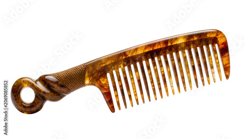 Isolated elegant tortoise shell comb with decorative handle for hair styling and grooming