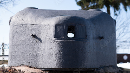 Photos Low-profile concrete pillbox bunker set on slightly snow-covered earth with cent