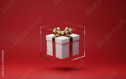 Gift box with gold ribbon encased in a transparent acrylic cube against a red background present