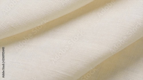 Natural cotton with linen fabric folds, white homespun vintage fabric, natural eco folded linen background. Bio textile material backdrop, canvas top view, close up, rotating