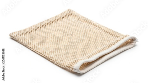 A beige knitted blanket folded neatly on a white background