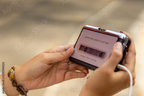 Hand holding a walkman. A device for listening to old music stored on cassettes.