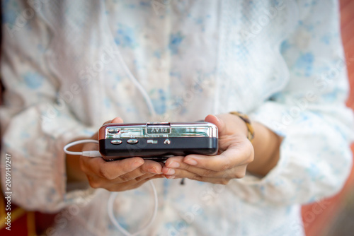 Hand holding a walkman. A device for listening to old music stored on cassettes.