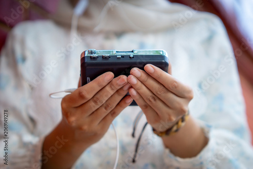 Hand holding a walkman. A device for listening to old music stored on cassettes.