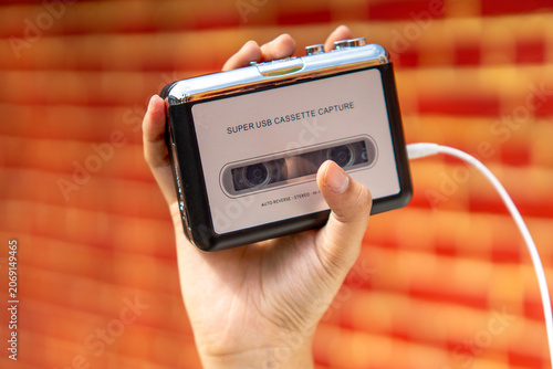 Hand holding a walkman. A device for listening to old music stored on cassettes.