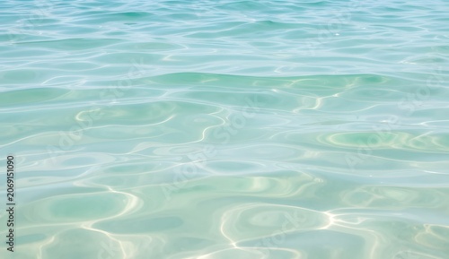 Clear calm ocean water with gentle sunlight reflection creating peaceful and refreshing natural sea scene