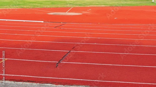 The damaged athletics track and field  , sports field.