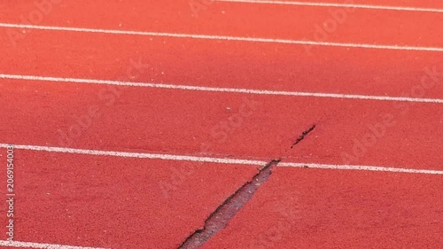 The damaged athletics track and field  , sports field.
