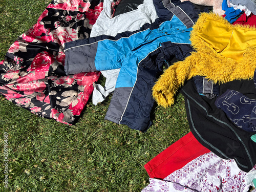 Schilderij op canvas used clothes pile fabric textile colorful surface messy arrangement on grass, di