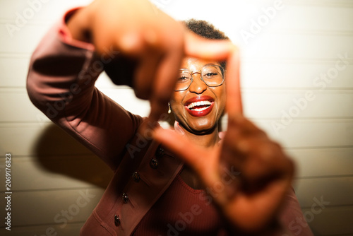 Happy african woman having fun at night time taking photos - Party, nightlife and people lifestyle concept - UGC flash content - Main focus on face