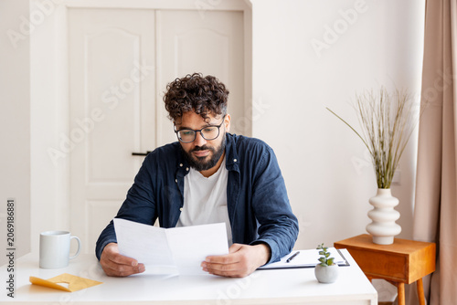 Fotografía Man reading important document or letter indoors