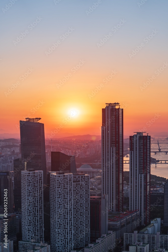 Fototapeta premium Golden sunset over the financial district of Yeouido with modern corporate skyscrapers in Seoul, South Korea