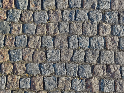 Schilderij op canvas Texture of stone pavement showing rough surface with irregular shapes and colors