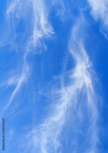 Wispy cirrus clouds in the bright blue sky