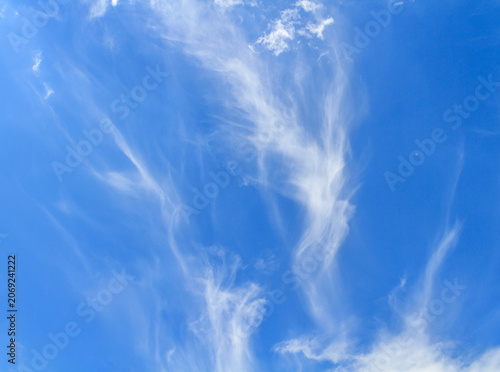 Wispy cirrus clouds in the bright blue sky