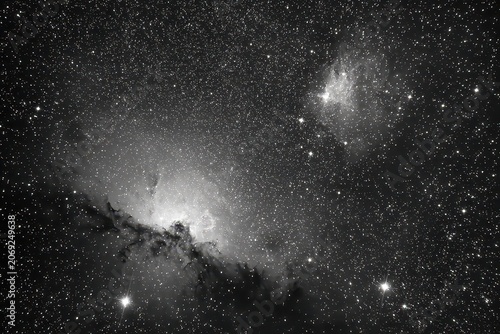 Deep Space Celestial Panorama Featuring Two Luminous Nebulae Against A Star-Studded Dark Night Sky In Shades Of Gray And White