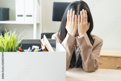 Fotografie Unemployed, quite job, desperate asian young businesswoman resigning from company packing belongings, stuff in box cardboard, layoff or leaving, changing work
