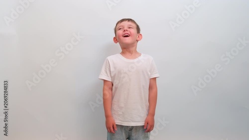 Surprised boy with mouth open looking to the side. Little child showing amazement and excitement. Expression of shock, wonder, or unexpected discovery. Emotional portrait of a youth.
