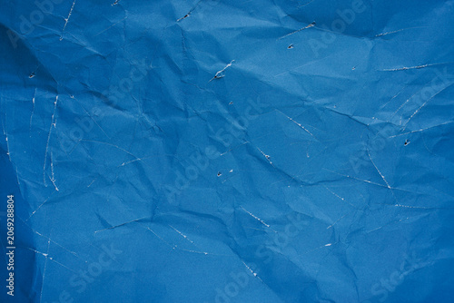 Canvas Print Distressed blue paper texture background with crumpled surface and white scratch