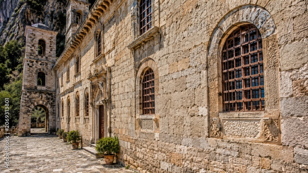 Fototapeta premium Historic stone monastery or church building with mountain backdrop