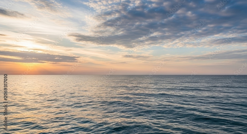 Fototapeta premium Vast Ocean Horizon at Sunset with Dramatic Clouds.
