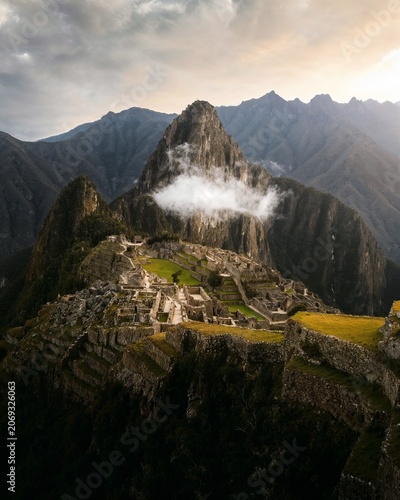 Discover the legendary beauty of Machu Picchu surrounded by majestic Andean peaks and dramatic clouds. An iconic destination blending ancient history, culture, and breathtaking natural landscapes.