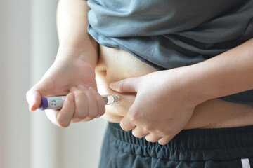 Hand Holding Weight Loss Injection Pen, Medical Treatment and Healthcare Copcept.