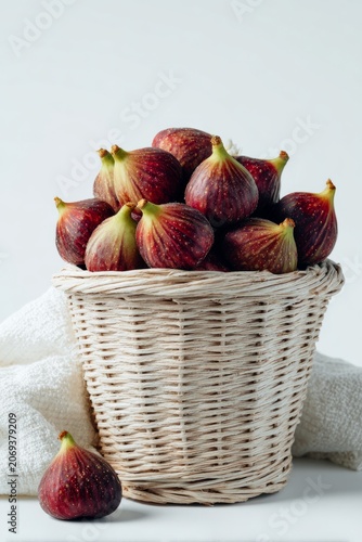 Fresh ripe figs filling wicker basket with fruit bounty