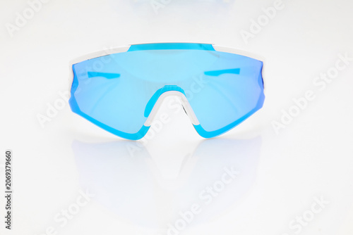 stylish sunglasses on a glossy white table, blue glass, white sunglasses frame, yachting glasses, cycling glasses, reflection on a glossy surface