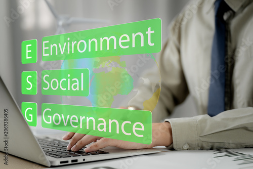 ESG. environment social governance investment business concept. Businessmen use a computer to analyze ESG, surrounded by ESG icons close to the computer screen in business investment strategy concept.