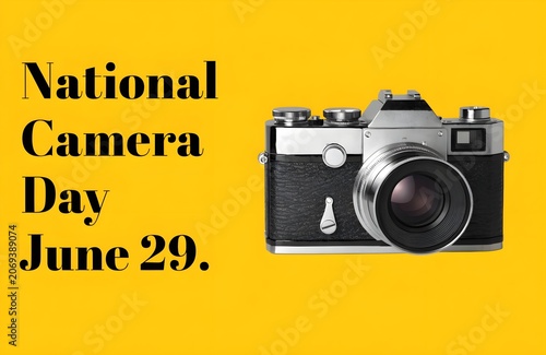 Vintage film camera on a bright yellow background for national camera day