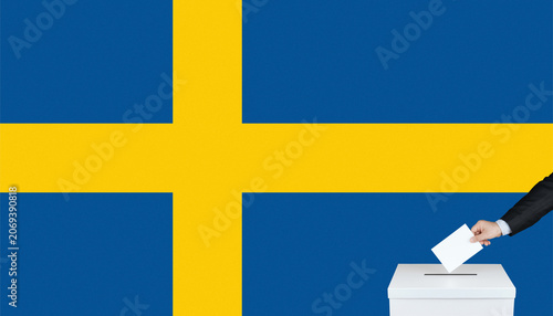 Fotografija Sweden general elections 2026 concept with voter hand putting ballot paper in box over swedish flag background