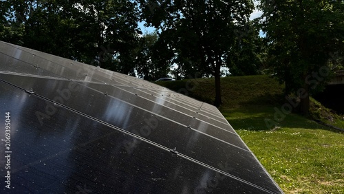 Solar Panels Reflecting Blue Sky and Clouds, Renewable Energy Concept, Clean Electricity Technology