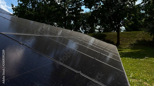 Solar Panels Reflecting Blue Sky and Clouds, Renewable Energy Concept, Clean Electricity Technology