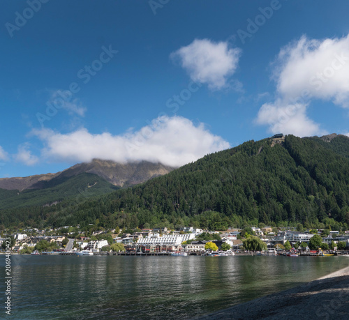 View at the town of Queenstown South island from the lake shoreline with beach. Lake Wakatipu