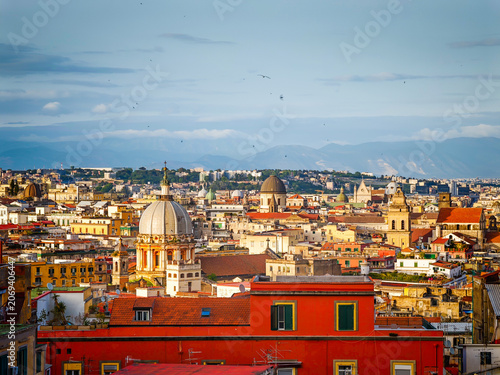Aerial drone view of Naples old town panorama and roofs of Naples residential buildings, scenic cityscape of historic center and iconic volcano view in Italy