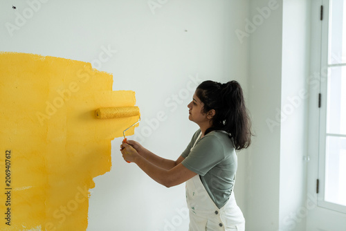 Photography Woman painting wall yellow photo