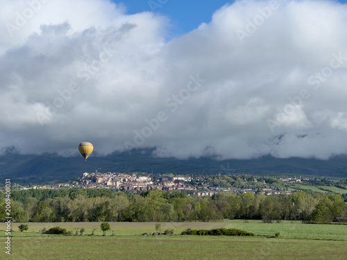 Hot air balloon flying over Puigcerda village