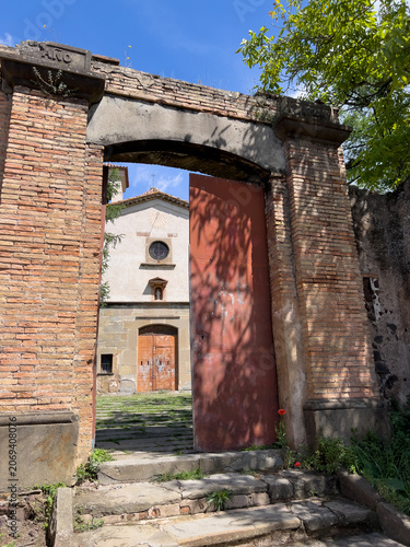 Ancient brick archway revealing rural chapel in Catalonia