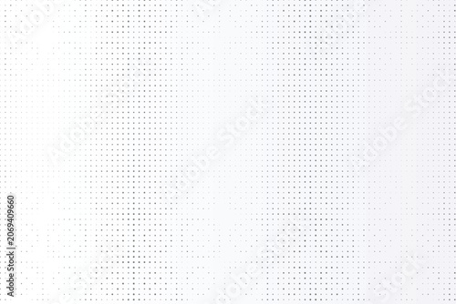 Tableau sur toile Subtle halftone pattern with varying gray dot sizes on a light off-white backgro
