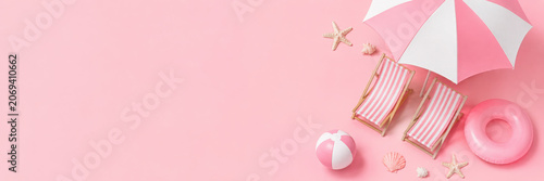 Top view Beach umbrella with chairs and beach accessories on pastel pink background. summer vacation concept. 3d rendering