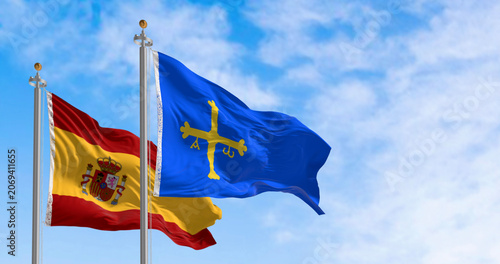 Fotografija The Asturias flag waving with Spanish flag on a clear day