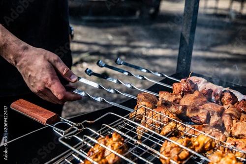 Εκτύπωση καμβά Appetizing kebabs on skewers over charcoal in a barbecue grill in nature