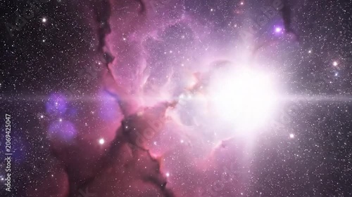 A vibrant purple nebula glows amidst a vast field of distant stars