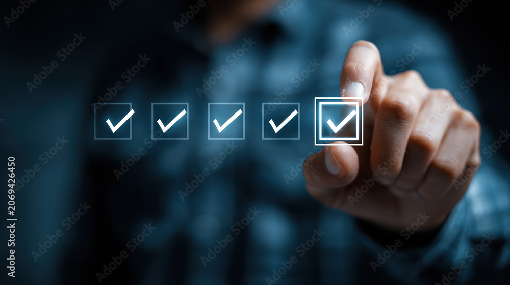Fototapeta premium Businessman pressing glowing golden checkbox in digital interface row on dark blue background concept