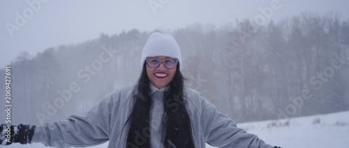 Happy Latina Woman from Colombia Enjoying Snow in Germany During Winter