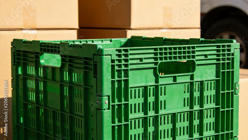 Green plastic crate in warehouse setting