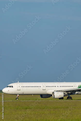 Passenger airplane taxing on runway at Hostivice airport